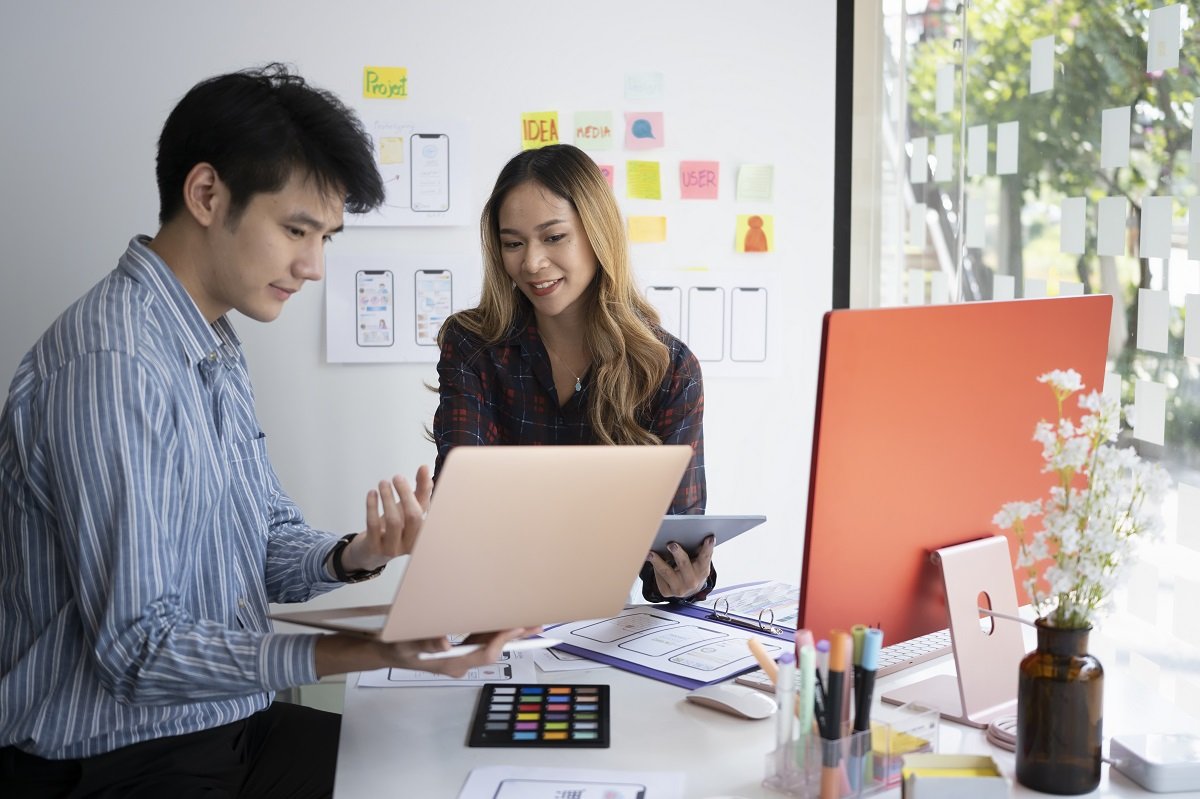 A man and woman working together to design a website.