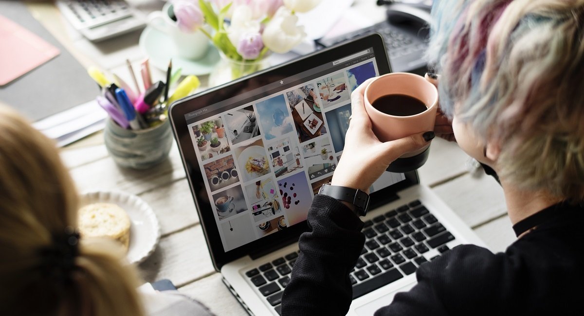 A woman looking at photos in a search engine on a laptop